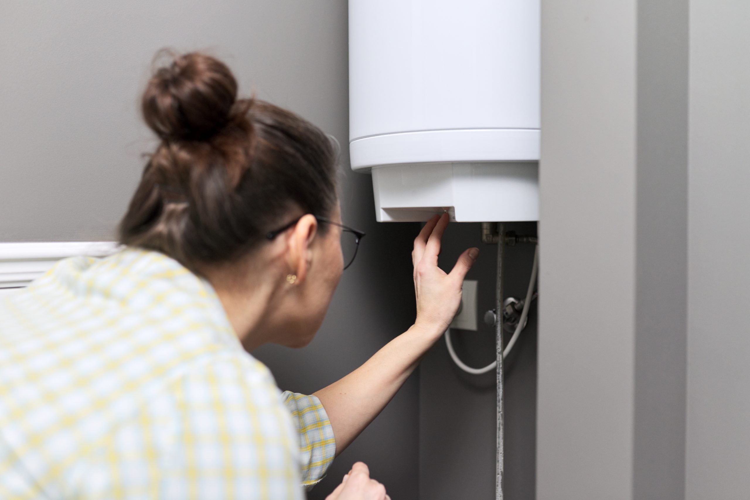 Home Water Heater Woman Regulates The Temperature 2022 01 20 19 53 30 Utc
