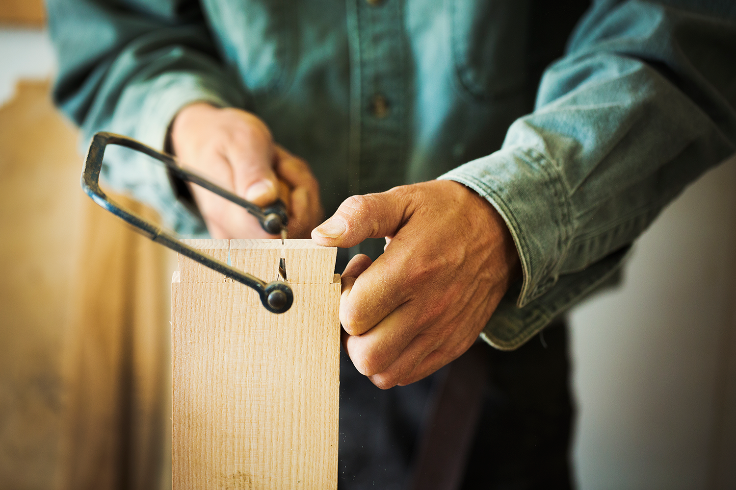 A Man Using A Handsaw On A Piece Of Wood 2023 11 27 05 27 04 Utc