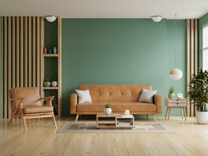 Living Room With Leather Sofa And Leather Armchair On Empty Dark Green Wall Background